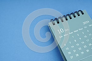 October 2024 desk calendar on blue color background. C