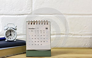 October 2024. Monthly desk calendar for 2024 on the table. Home office