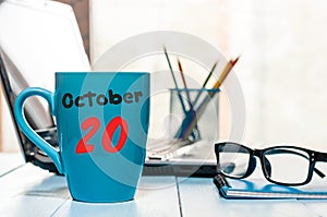 October 20th. Day 20 of month, calendar on blue tea cup at Software Engineer workplace background. Autumn time. Empty