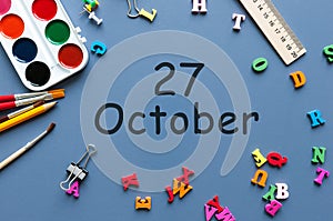 October 27th. Day 27 of october month, calendar on teacher or student table, blue background . Autumn time