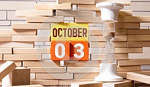 october 3. 3th day of month, calendar date.White vase with dead wood next to cork board with numbers