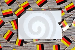 October 3, happy Day of German unity. the concept of patriotism , freedom and independence. Mini flags with a white card on wooden
