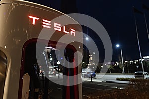 October 20, 2022 Astana, Kazakhstan: Empty Tesla electric car charging station against the backdrop of the city at night