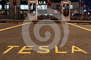 October 20, 2022 Astana, Kazakhstan: Empty Tesla electric car charging station against the backdrop of the city at night