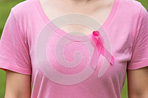 October Breast Cancer Awareness month, adult Woman in pink T- shirt and Pink Ribbon for supporting people living and illness.