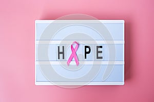 October Breast Cancer Awareness month, Pink Ribbon on lightbox with HOPE text background for supporting people living and illness
