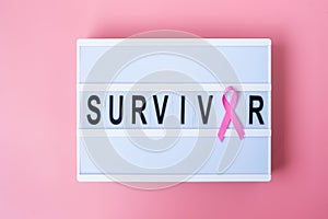 October Breast Cancer Awareness month, Pink Ribbon on lightbox with SURVIVOR text background for supporting people living and