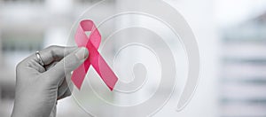 October Breast Cancer Awareness month, Woman holding Pink Ribbon for supporting people living and illness. Healthcare, photo