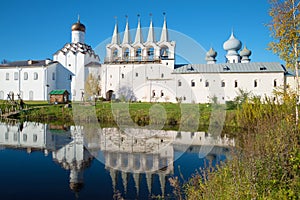 October day in the monastery pond. View of the bell tower of the Tikhvin Assumption monastery, Russia