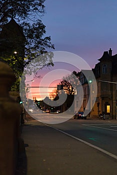 on an october fall evening buildings, lightened windows and streets the sky is illuminated with rainbow colors