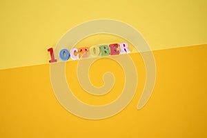 October 1 . First Day, October 1 wooden calendar on yellow abstract background photo