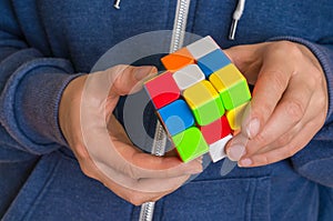 Rubik`s cube in female hands - game for solving problems