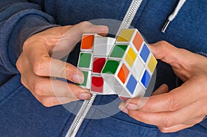 Rubik`s cube in female hands - game for solving problems