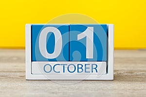 October 1st . First day, October 1 blue wooden calendar on yellow abstract background. Autumn day photo