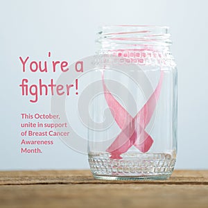 This october unite in support of breast cancer awareness month text, pink ribbon in glass jar