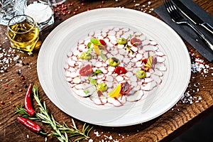 Octopus carpaccio. Spinach cream, cherry tomatoes. Delicious healthy Italian traditional food closeup served for lunch