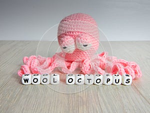 Octopus-shaped wool toy, pink color photo