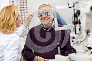 Ocular specialists work with patient on eye clinic