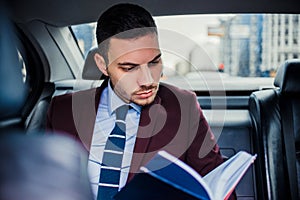 Ocupated businessman in a limo