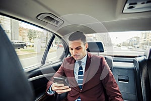 Ocupated businessman in a limo