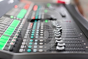 Od adjusters and red buttons of a mixing console. It is used for audio signals modifications to achieve the desired photo