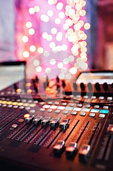 Od adjusters and red buttons of a mixing console. It is used for audio signals modifications to achieve the desired photo