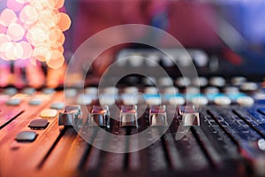 Od adjusters and red buttons of a mixing console. It is used for audio signals modifications to achieve the desired photo