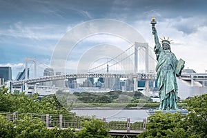 Odaiba Statue of Liberty with rainbow bridge and skyscraper background