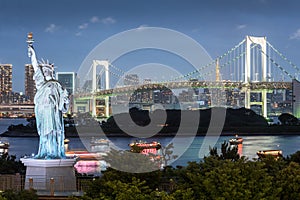 Odaiba Statue of Liberty with rainbow bridge and Tokyo tower in evening