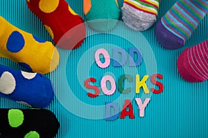 Odd Socks Day. Day lost socks, lonely socks on blue background.