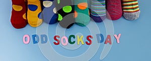 Odd Socks Day. Day lost socks, lonely socks on blue background.