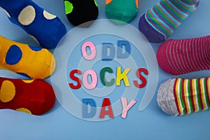 Odd Socks Day. Day lost socks, lonely socks on blue background.