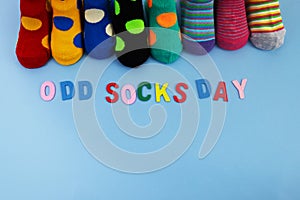 Odd Socks Day. Day lost socks, lonely socks on blue background.