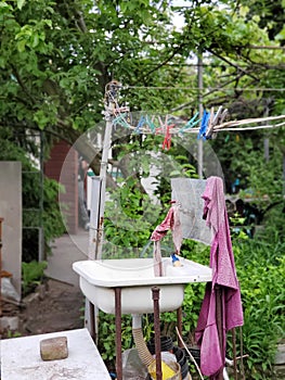 oddly open washstand on the backyard or country house