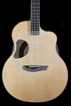 Oddly shaped acoustic guitar with a unique sound hole shaped like a kidney bean