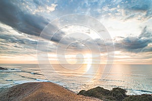 Odeceixe beach under the sun at sunset. The beauty of the Algarve region on the Atlantic coast of western Portugal. In the