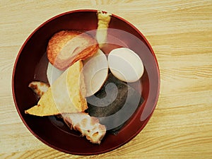 Oden with hot soup on wooden table