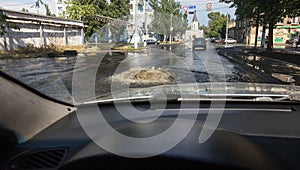 Odessa, Ukraine -3 July 2018: Driving cars on a flooded road during floods caused by rain storms. Cars float on water, flooding st