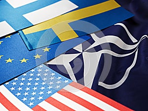 Odessa, Ukraine, February 24, 2023. USA Flags of Sweden, Turkey, Finland, EC, against the background of the symbol of the NATO