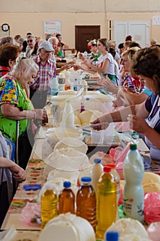 Odessa, Ukraine - July 18, 2019. Privoz market. Buyers taste and choose organic farm dairy products. Indoor