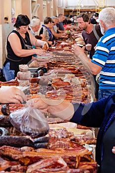 Odessa, Ukraine - July 18, 2019. Privoz market. Various smoked meats, sausages and bacon on a market counter for sale