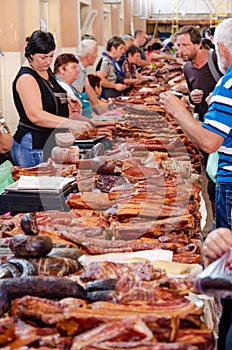 Odessa, Ukraine - July 18, 2019. Privoz market. Various smoked meats, sausages and bacon on a market counter for sale