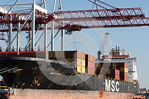 Odessa, Ukraine-202: Logistics terminal sends import-export cargo containers to cargo ship in seaport. Industrial landscape with