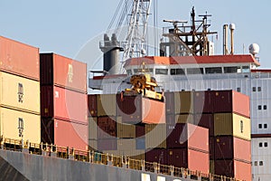 Odessa, Ukraine-202: Logistics terminal sends import-export cargo containers to cargo ship in seaport. Industrial landscape with