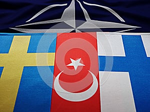 Odessa, Ukraine, March 02, 2023. USA flags of Finland, Sweden, Turkey, against the background of the symbol of the NATO