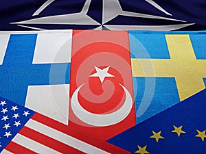 Odessa, Ukraine, March 02, 2023. USA flags of Finland, Sweden, Turkey, against the background of the symbol of the NATO