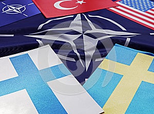 Odessa, Ukraine, March 02, 2023. USA flags of Finland, Sweden, Turkey, against the background of the symbol of the NATO