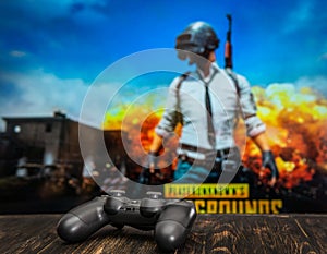 Odessa, Ukraine - May 12, 2019. Black playstation 4 gamepad on the background of the game PUBG.  PLAYERUNKNOWN`S BATTLEGROUNDS