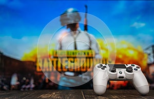 Odessa, Ukraine - May 13, 2019. White playstation 4 gamepad on the background of the game PUBG.  PLAYERUNKNOWN`S BATTLEGROUNDS