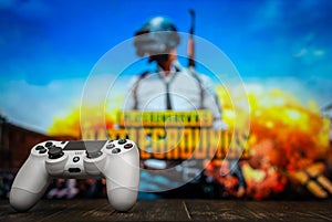 Odessa, Ukraine - May 13, 2019. White playstation 4 gamepad on the background of the game PUBG.  PLAYERUNKNOWN`S BATTLEGROUNDS